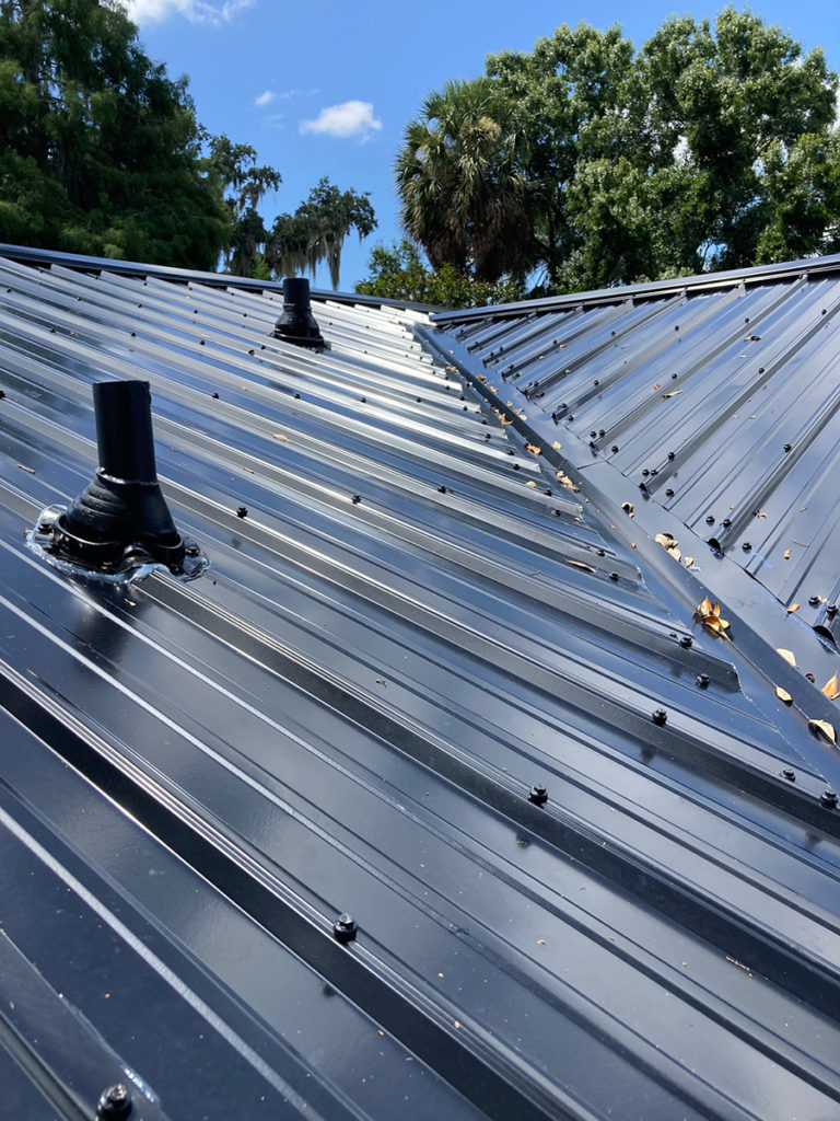 Close-up of metal roofing panels and vent flashing installed by Southern Pro Roofing in Florida